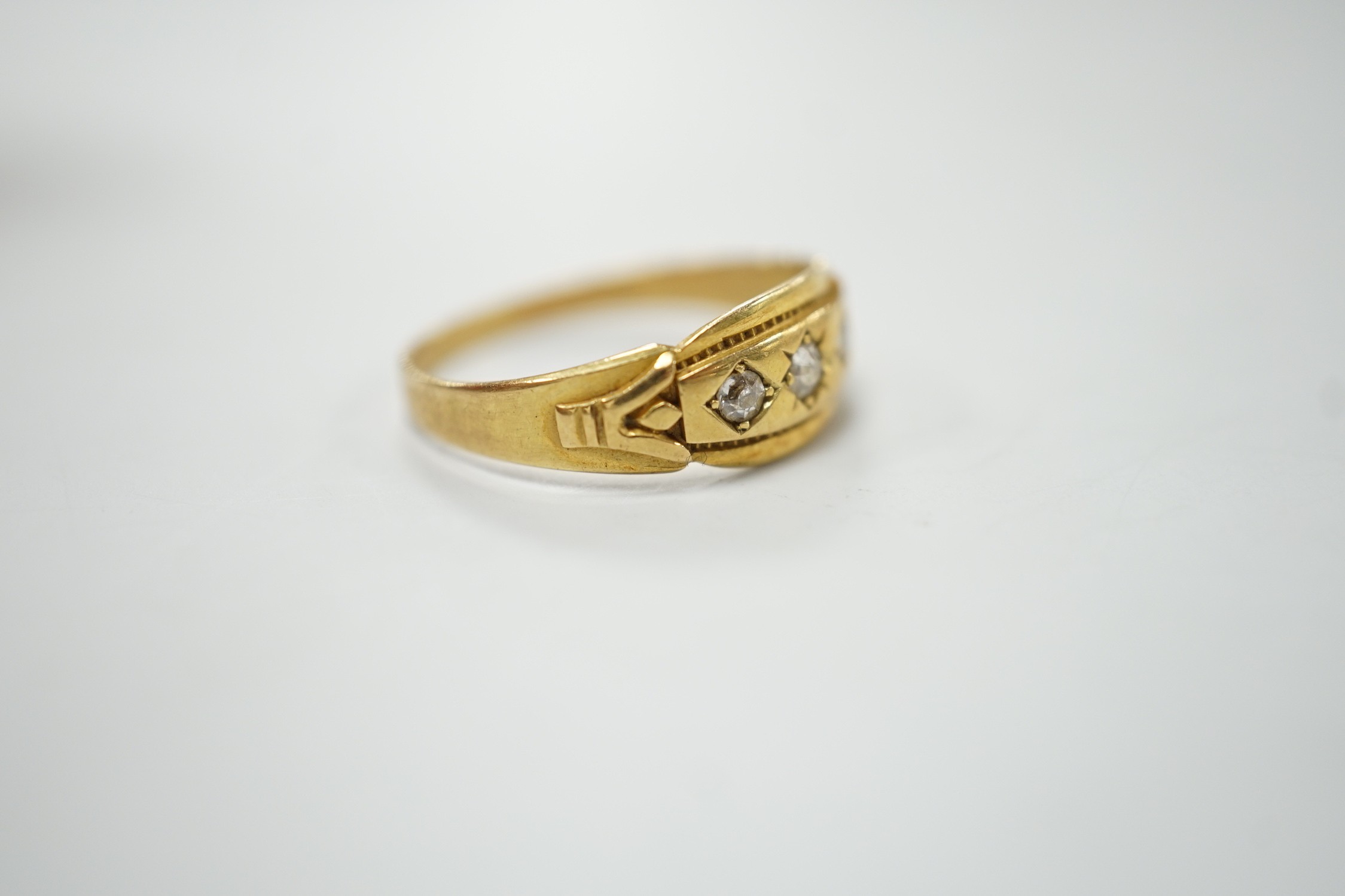 A late Victorian 18ct gold and gypsy set three stone diamond ring, size Q, gross weight 2.8 grams.